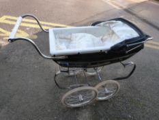 A Silver Cross pram with blue and white body,
