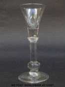 George II drinking glass with trumpet bowl over annular knopped baluster stem and lower swollen