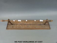 A wall mounted towel rail with carved oak back dated 1893 (length 72cm)