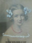 An early 20thC gouache highlighted portrait of a young girl,