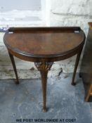 A walnut carvied demi lune table raised on cabriole legs (H78cm x W77cm x D44cm)