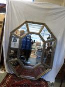A large bevelled glass octagonal sectional mirror (H160cm x W129cm)
