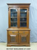 A Victorian glazed mahogany and ash bookcase with cupboard under,