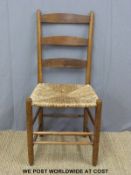 An Arts and Crafts Phillip Clisset or similar rush seated and peg jointed ash ladder back chair,
