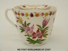 A 19thC moustache cup with floral and foliate decoration and SH 1884 to base