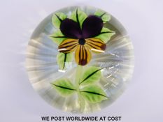 William Manson glass paperweight with central purple and yellow pansy and signature cane on star