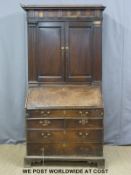 A Georgian oak bureau bookcase/cabinet with fall flap and lectern front,