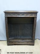 A carved oak bookcase with dog tooth adjustable shelving (H108xW93xD31cm)