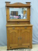 An Art Nouveau/Art and Crafts oak bevelled glass mirror back sideboard with pierced decoration