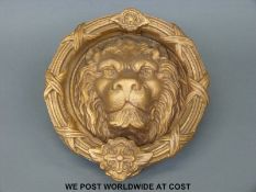 A brass or similar lion mask door knocker of unusually large proportions,
