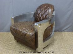 An Art Deco style quilted leather and polished metal armchair