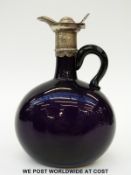 A white metal mounted amethyst glass ewer with applied handle,