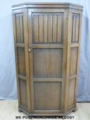 A panelled oak and linen fold wardrobe with canted corners (H181xW97xD46cm)