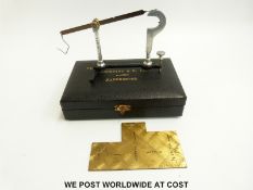 A cased Beesley's yarn balance with brass plate marked linen,