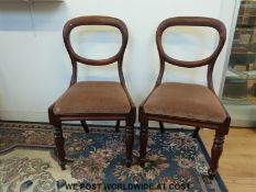 A set of six upholstered Victorian mahogany balloon back chairs with turned front legs and sabre
