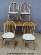 An Ercol light elm dining table (H72 x W155 x W76cm) and four dining chairs
