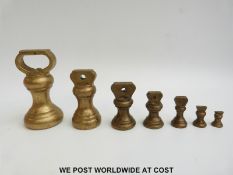 A set of seven brass bell weights (11lb downwards)