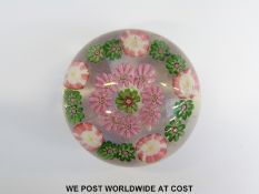 Clichy patterned millefiori glass paperweight with central pink and green cane surrounded by eight