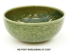 A studio pottery bowl with green glaze and initials to front (27cm diameter)