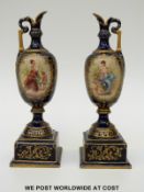 A pair of Vienna porcelain ewers with hand-painted decoration on a white and blue ground (21cm