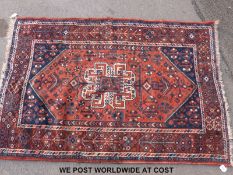 An Turkoman wool rug with geometric design on red ground (154x109cm)