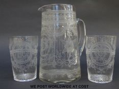A clear glass jug and two matching beakers, all with elaborate engraved decoration, jug 18cm tall.