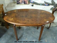 An inlaid walnut oval coffee table (H63cm x L108cm x W62cm)