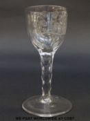 An 18thC wine glass with round funnel bowl engraved with Jacobite roses and bee over multi-faceted