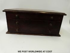 A 19th/20thC apprentice or collector's chest of three straight graduated drawers with multiple