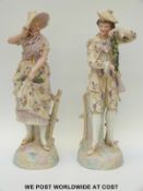 A pair of French bisque figures of a lady and gent displaying grapes (50cm tall)