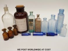 A collection of glass pharmaceutical jars and bottles, many with original paper labels.