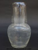 A clear glass decanter and up with engraved decoration, 17cm tall.