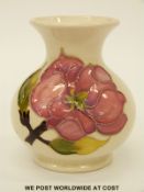 Moorcroft vase in Magnolia pattern on a cream ground (9.