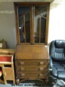 A glazed oak bureau bookcase (H192cm x W77cm x D45cm)