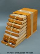 A small set of drawers containing brass and lead printing letters,