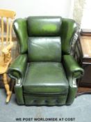 A green leather chesterfield style reclining armchair