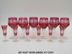 A set of six flash overlaid cut cranberry wine glasses (16cm tall) together with a similar set of