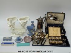 A pair of Wedgwood blanc de chine vases in the form of conch shells with coral supports,