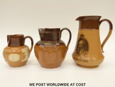 Two Doulton Lambeth King Edward VII 1902 coronation jugs and a King George V example (tallest 20cm)