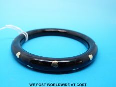 A gold inlaid or pique work tortoiseshell effect bangle,