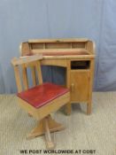 A beech child's roll top desk and leather swivel chair (H82cm x W73cm x D43cm)