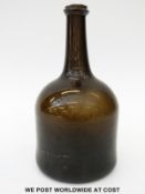 A late 18th century mallet shaped olive green/ brown glass bottle with deep base, 22cm tall.