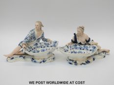 A pair of large Meissen figural sweetmeat dishes in blue and white