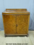 An oak cabinet with two drawers and shelf within raised on bun feet (H110 x W101 x D50cm)