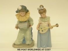 Two Nao figures of children playing mandolin and squeeze box