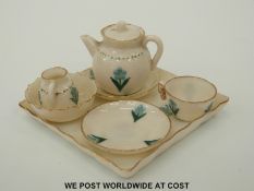 A miniature WH Goss tea set in forget me not pattern with teapot, milk jug, tea cup,