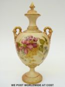 Royal Worcester blush ivory twin handled lidded pedestal vase decorated with flowers,