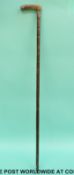 A white metal mounted horn and cane walking stick.