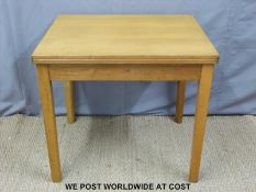 A contemporary light oak table with swivel and fold over facility doubling the size (H77cm x W84cm