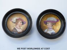 A pair of porcelain concave plaques in the Vienna style of ladies in late 18th/19thC dress,